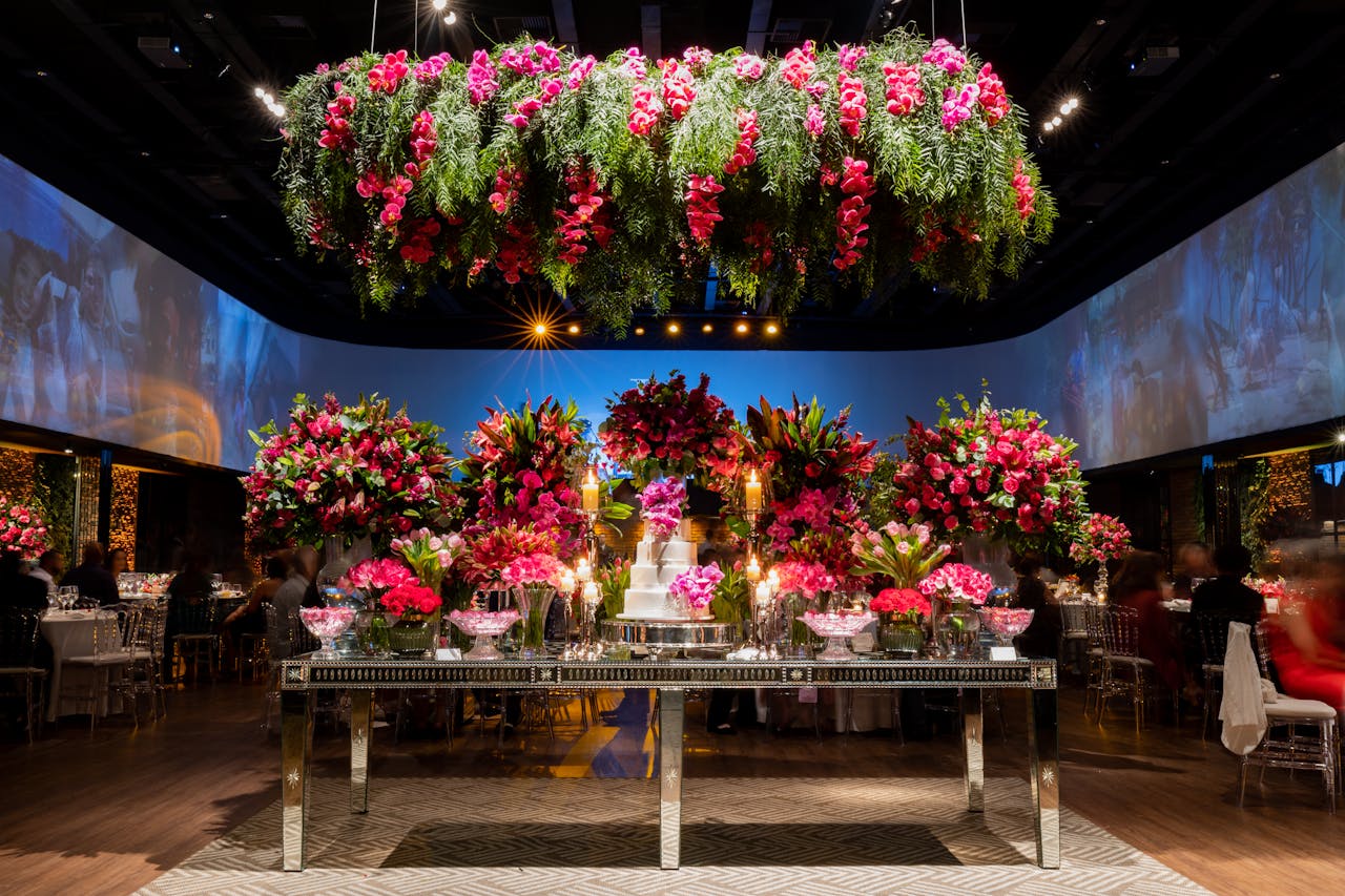 Home A stunning wedding reception venue adorned with vibrant floral arrangements and a central cake display.